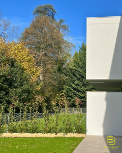 An outside view of the home with a geometric design and flat roof.