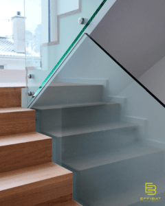 Another staircase with glass balustrade and wooden steps