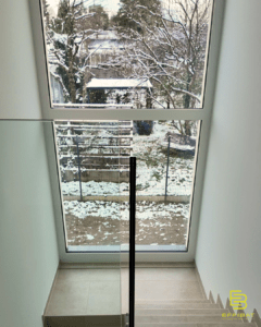 A large picture window fills the landing of the staircase to the second floor in each of the two villas