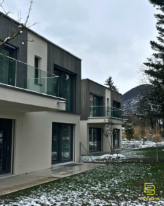 A view of the two homes from the exterior - we can see wood siding and the mountain in the background