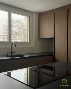 the kitchen at Rasses 47 with black countertops and honey colored wood